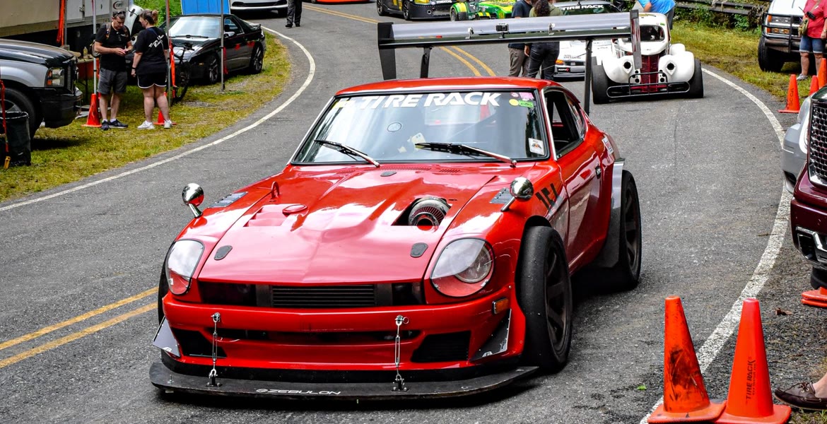 A red Datsun Z with a full aero package staged on a closed mountain road at an Appalachian Hillclimb round.