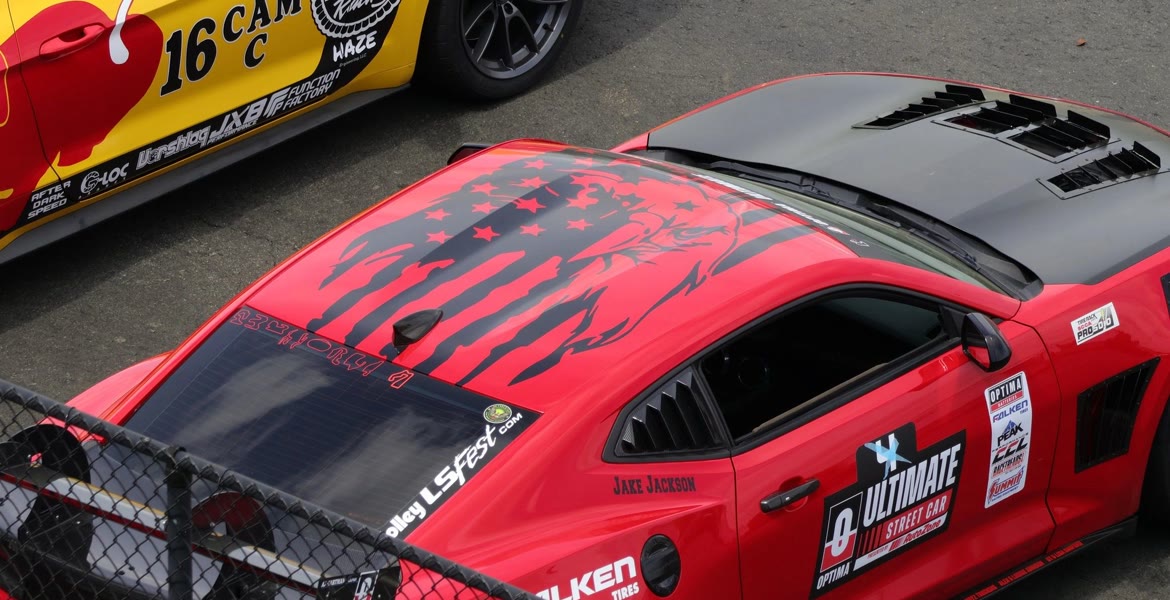 Two fully prepared race cars sitting on the grid before a session.